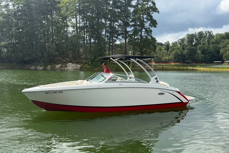 Slide: The Image of 2019 Cobalt R5 boat on a serene lake with lush green trees. - 17