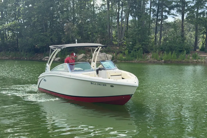 Slide: The Image of 2019 Cobalt R5 boat cruising on a serene lake surrounded by lush trees. - 7
