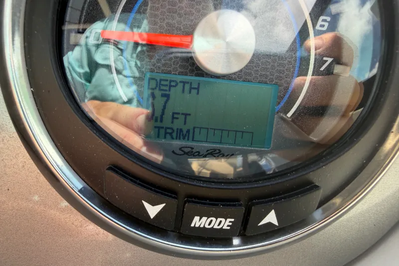 Slide: The Image of Close-up of Sea Ray 290 Sundeck Outboard gauge displaying depth at 7 feet. - 10