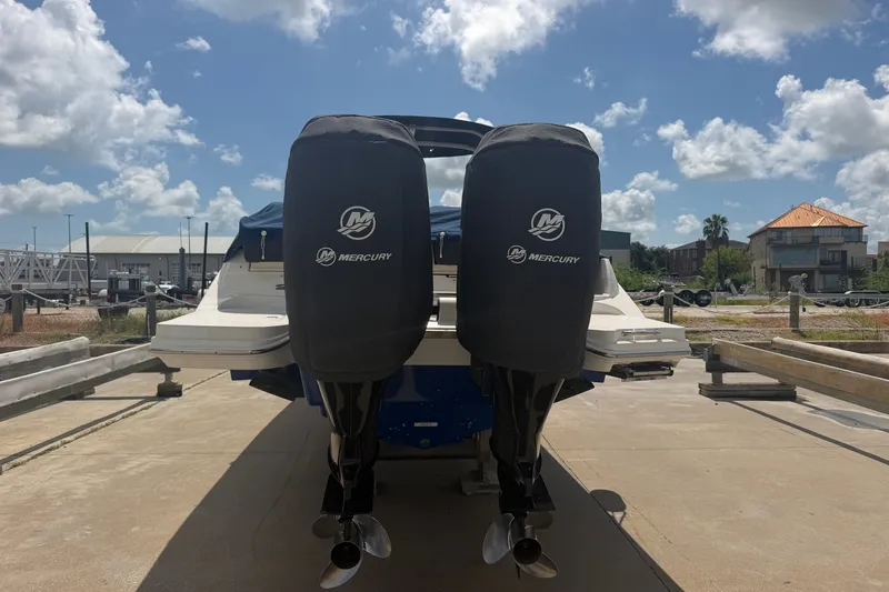 Slide: The Image of 2016 Sea Ray 290 Sundeck Outboard with twin Mercury engines, docked under a sunny sky. - 4