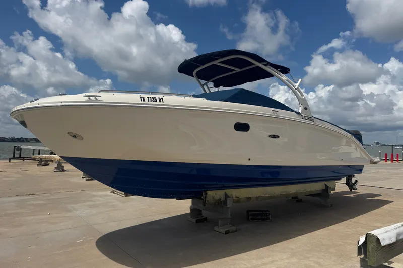 Slide: The Image of 2016 Sea Ray 290 Sundeck Outboard boat on dock under blue sky. - 2