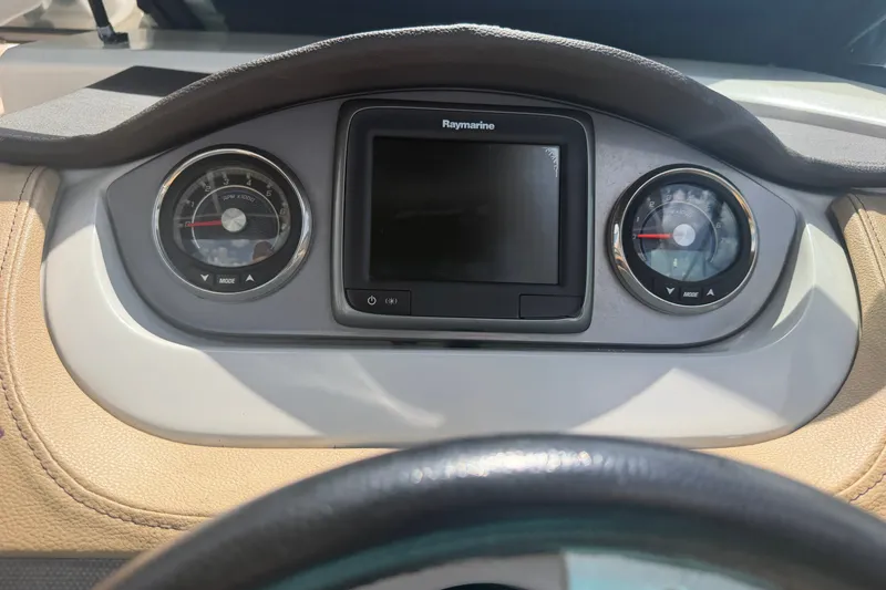 Slide: The Image of Dashboard of 2016 Sea Ray 290 Sundeck Outboard with gauges and Raymarine display. - 11