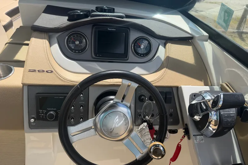 Slide: The Image of 2016 Sea Ray 290 Sundeck Outboard dashboard with steering wheel and controls. - 8