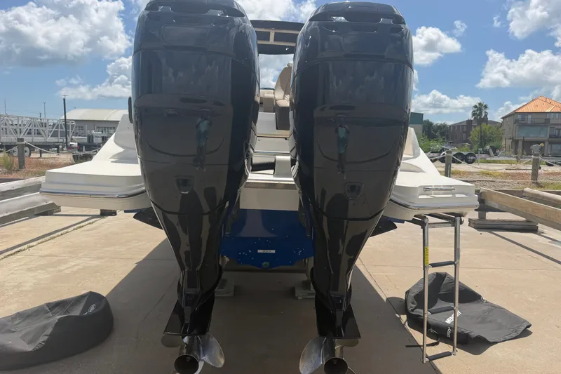Slide: The Image of 2016 Sea Ray 290 Sundeck Outboard with dual engines, docked under a sunny sky. - 20