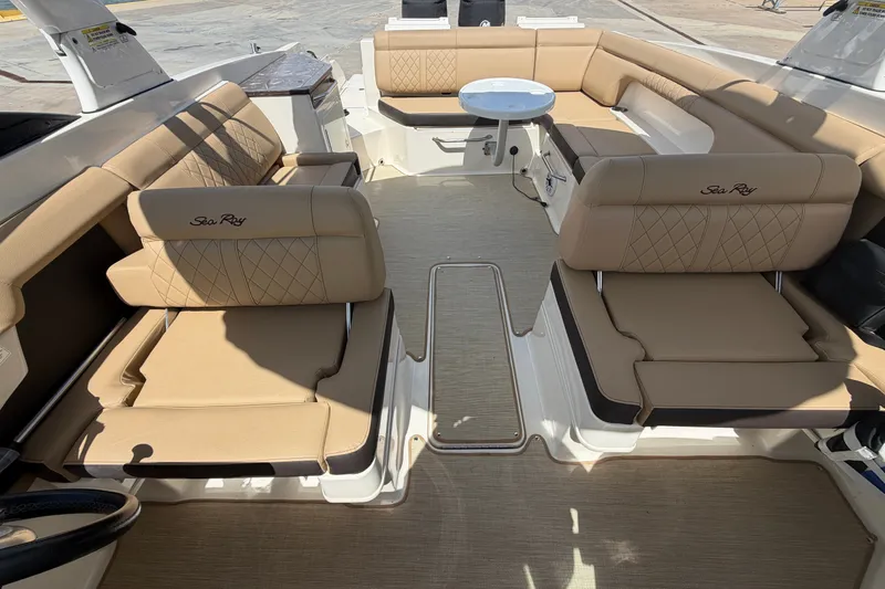 Slide: The Image of Luxurious interior of 2016 Sea Ray 290 Sundeck Outboard with beige seating and table. - 15