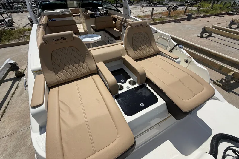 Slide: The Image of 2016 Sea Ray 290 Sundeck Outboard with tan seating and cup holders on deck. - 17