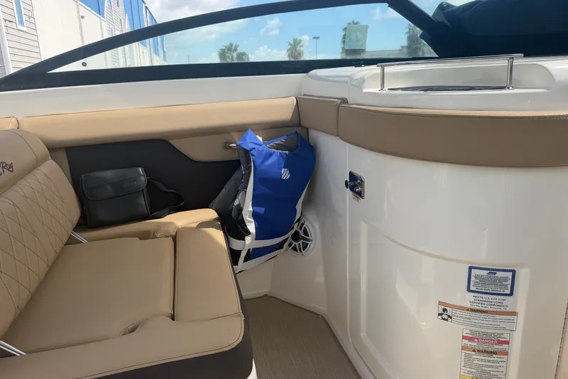 Slide: The Image of Interior of 2016 Sea Ray 290 Sundeck Outboard with beige seating and storage. - 12