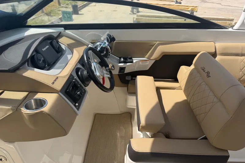 Slide: The Image of Interior of 2016 Sea Ray 290 Sundeck Outboard, featuring helm and beige seating. - 7
