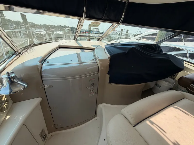 Slide: The Image of The image shows the cockpit of a 2004 Sea Ray 420 Sundancer with beige upholstery. - 15