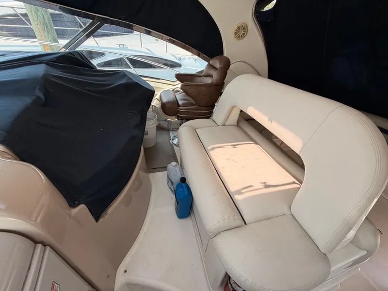Slide: The Image of The image shows the cockpit of a 2004 Sea Ray 420 Sundancer with beige leather seating. - 16