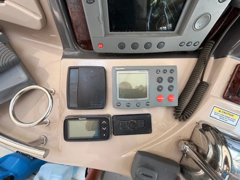 Slide: The Image of The image shows the dashboard of a 2004 Sea Ray 420 Sundancer with various navigation instruments. - 22