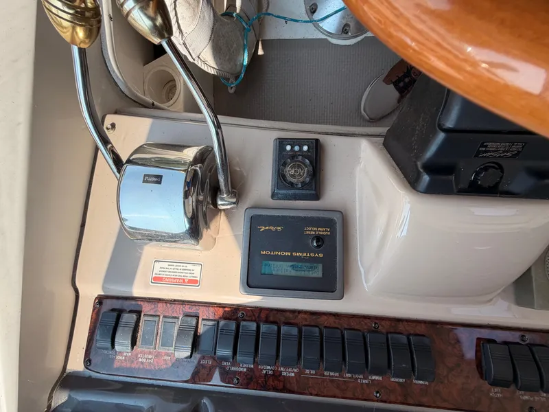 Slide: The Image of Close-up of a 2004 Sea Ray 420 Sundancer helm with switches and instruments. - 25
