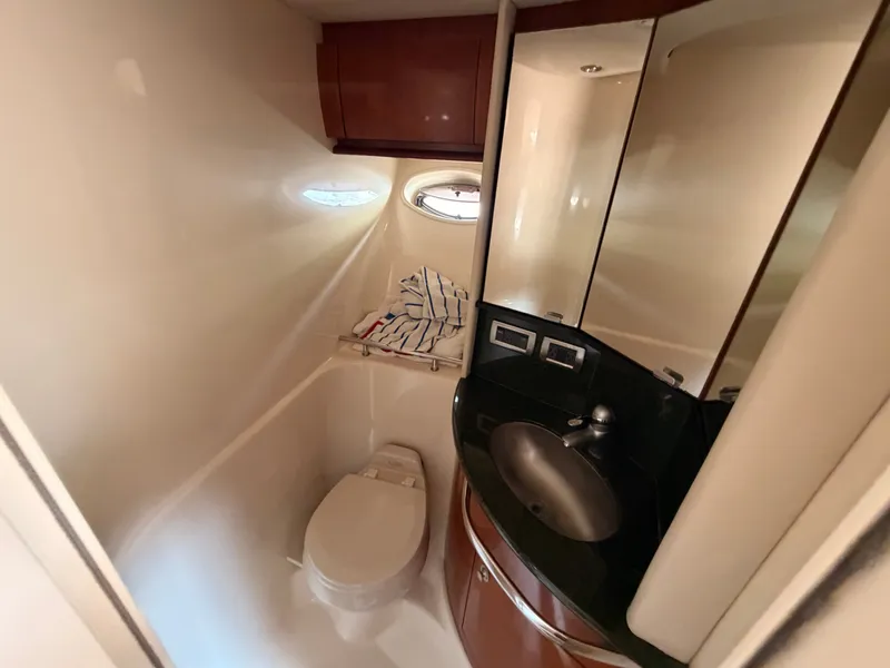 Slide: The Image of The image shows a boat bathroom with a toilet, sink, and mirror. - 43