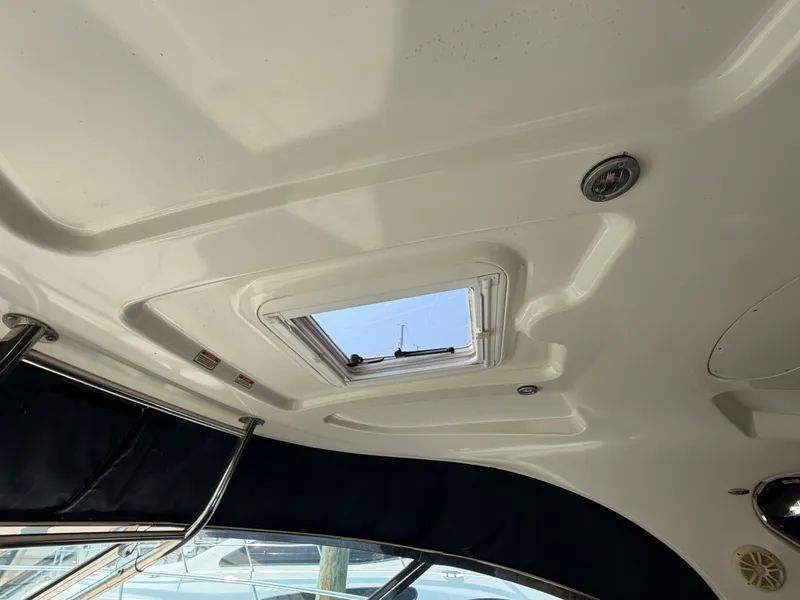 Slide: The Image of The image shows the ceiling of a 2004 Sea Ray 420 Sundancer with a skylight. - 17