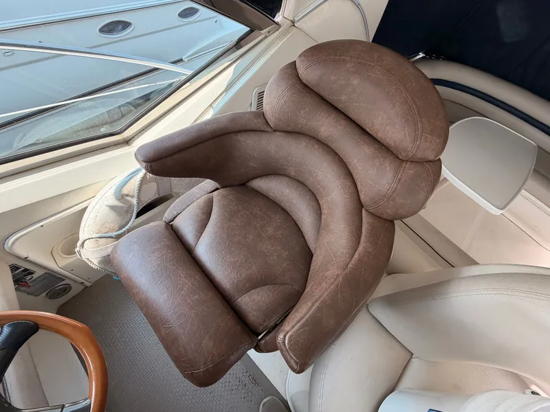 Slide: The Image of A luxurious, padded captain's chair in a 2004 Sea Ray 420 Sundancer. - 19