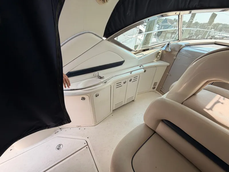 Slide: The Image of The image shows the cockpit of a 2004 Sea Ray 420 Sundancer with beige seats and helm console. - 14