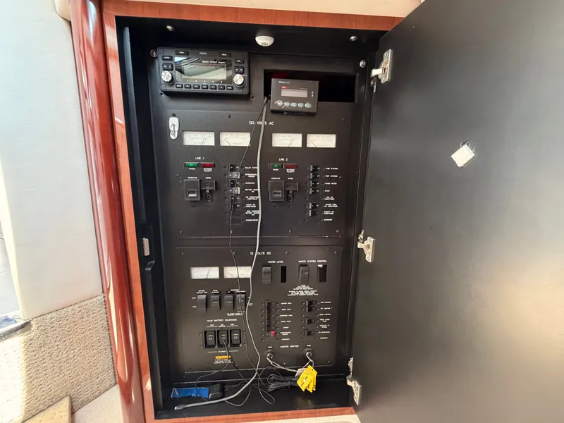 Slide: The Image of An electrical panel on a boat with various switches and displays. - 46