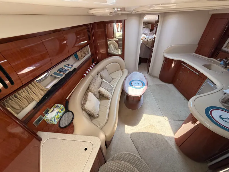 Slide: The Image of Interior of a 2004 Sea Ray 420 Sundancer with elegant wood accents and comfortable seating. - 28