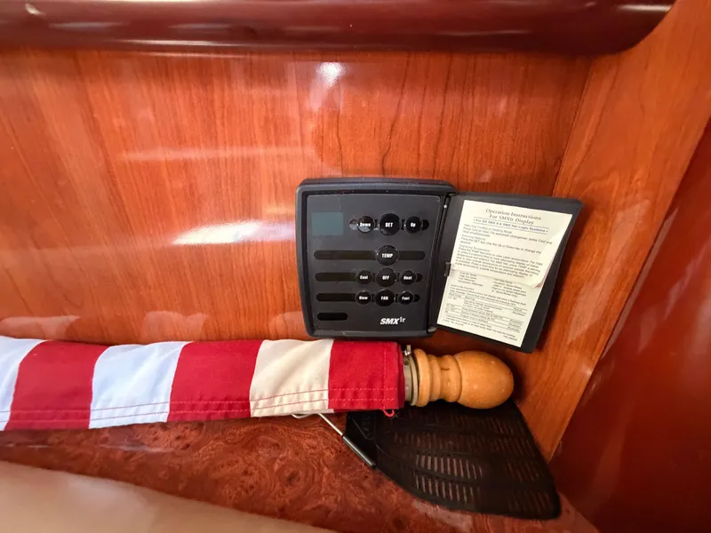 Slide: The Image of A control panel with buttons and an instruction manual is mounted on a wooden panel. - 45