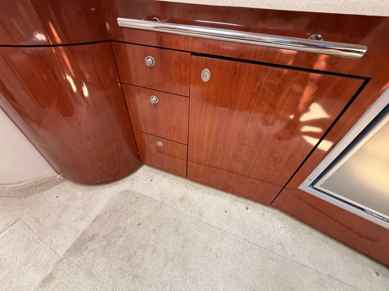 Slide: The Image of The interior view shows an elegant wood cabin with drawers and a refrigerator. - 37