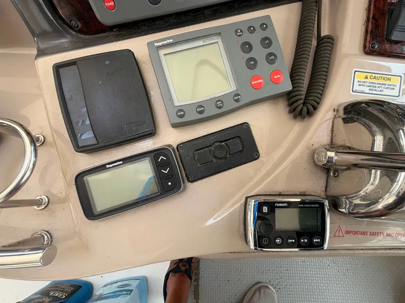 Slide: The Image of The image shows the dashboard of a 2004 Sea Ray 420 Sundancer with various instruments. - 23