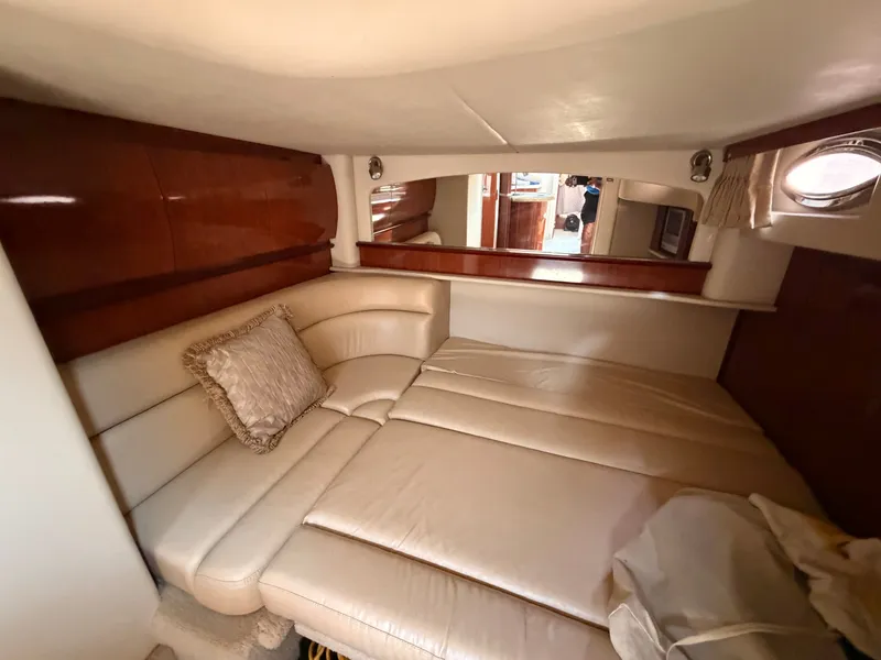 Slide: The Image of The 2004 Sea Ray 420 Sundancer cabin features an elegant cream leather sofa and wood accents. - 33