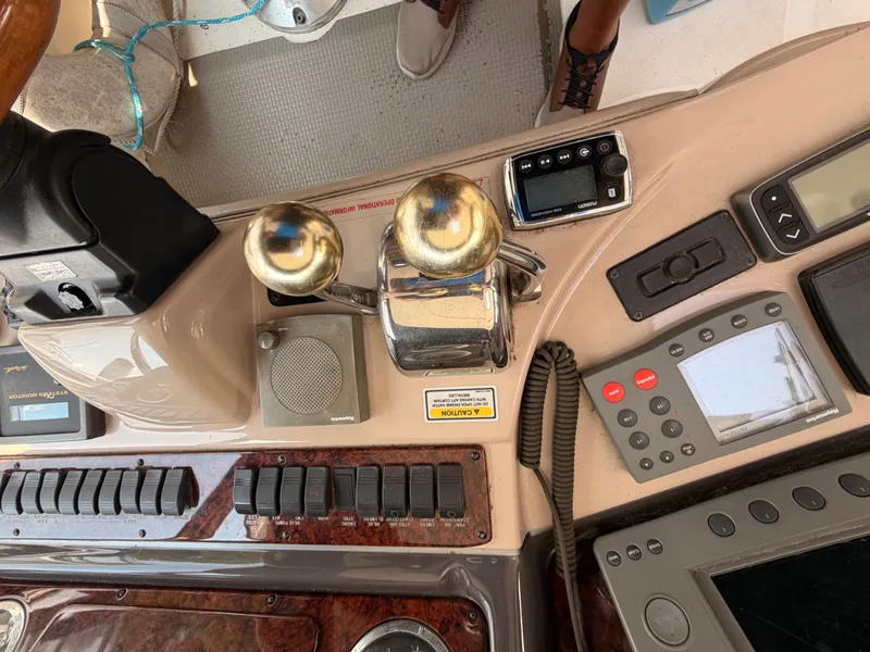 Slide: The Image of The image shows the helm of a 2004 Sea Ray 420 Sundancer with various instruments. - 24
