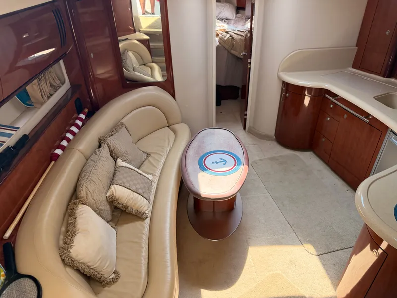 Slide: The Image of Interior of a 2004 Sea Ray 420 Sundancer with elegant seating area and kitchenette. - 27
