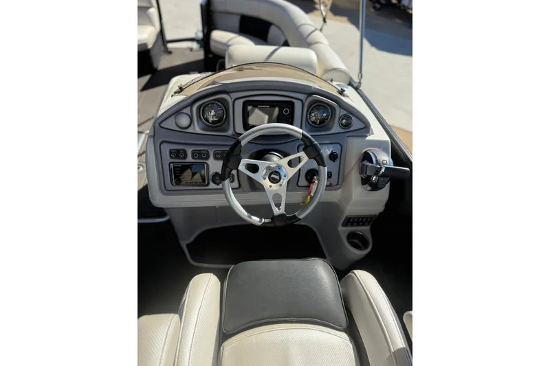 Slide: The Image of 2017 South Bay 500 Sport boat dashboard with steering wheel and controls. - 13