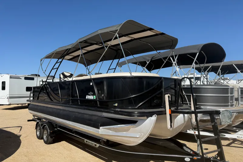 Slide: The Image of 2017 South Bay 500 Sport pontoon boat with canopy on trailer, parked outdoors. - 19