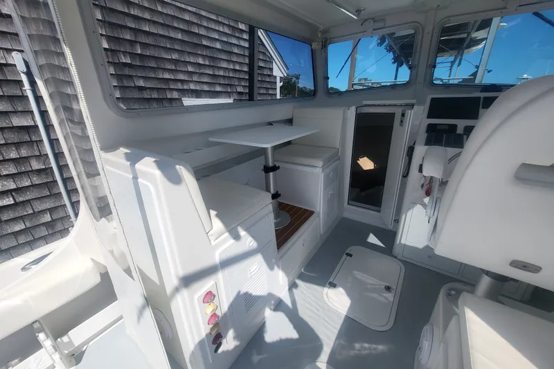 Slide: The Image of Interior of 2020 Steiger Craft 28 Miami boat, featuring seating and control panel. - 18