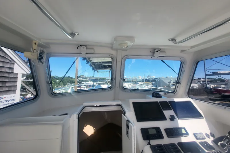 Slide: The Image of Interior view of 2020 Steiger Craft 28 Miami boat cockpit with navigation equipment. - 16