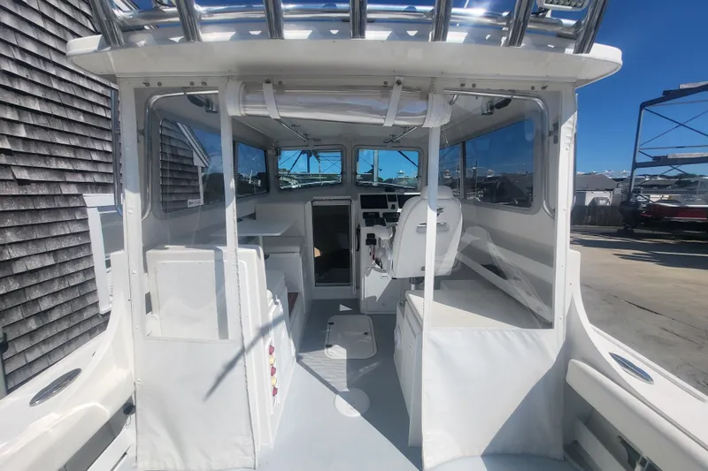 Slide: The Image of 2020 Steiger Craft 28 Miami boat interior with helm, seating, and windows. - 22