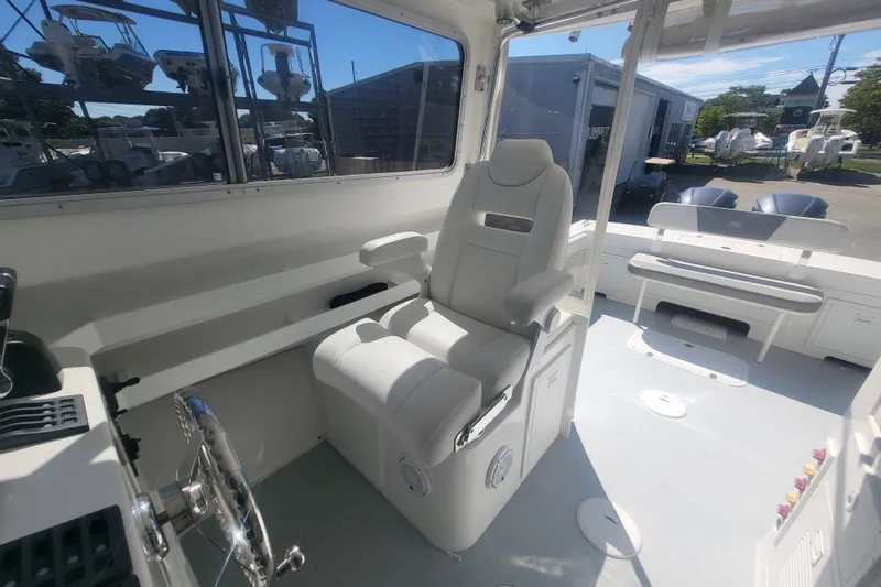 Slide: The Image of 2020 Steiger Craft 28 Miami boat interior with captain's chair and steering wheel. - 19