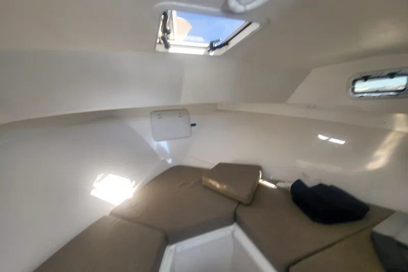 Slide: The Image of 2020 Steiger Craft 28 Miami cabin interior with cushions and windows. - 25