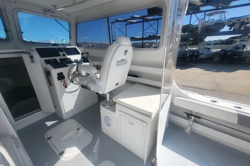 Slide: The Image of 2020 Steiger Craft 28 Miami boat interior with helm and seating area. - 17