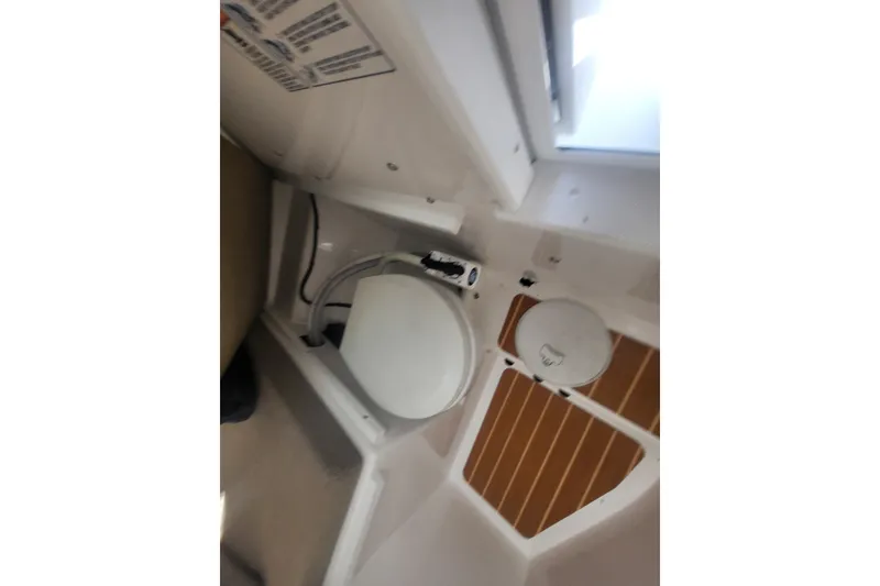 Slide: The Image of 2020 Steiger Craft 28 Miami boat interior with compact marine toilet. - 27