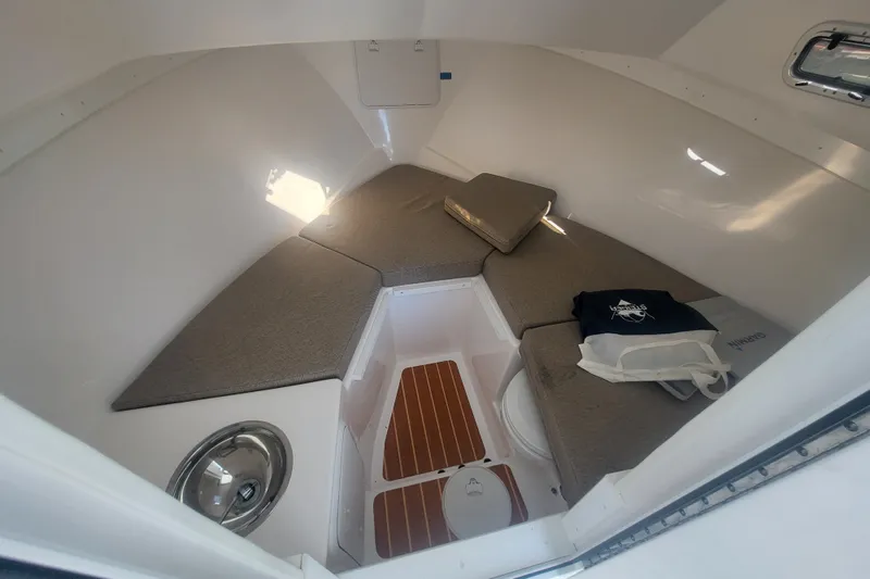 Slide: The Image of 2020 Steiger Craft 28 Miami cabin interior with cushions and wooden flooring. - 24