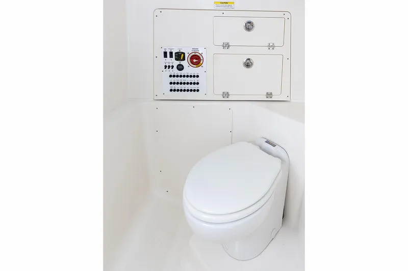 Slide: The Image of Manufacturer Provided Image: 2025 Pursuit S 248 Sport boat interior with toilet and control panel. - 17