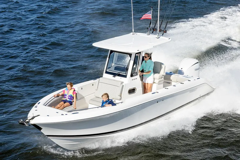 Slide: The Image of Manufacturer Provided Image: 2025 Pursuit S 248 Sport boat cruising with passengers on open water. - 1