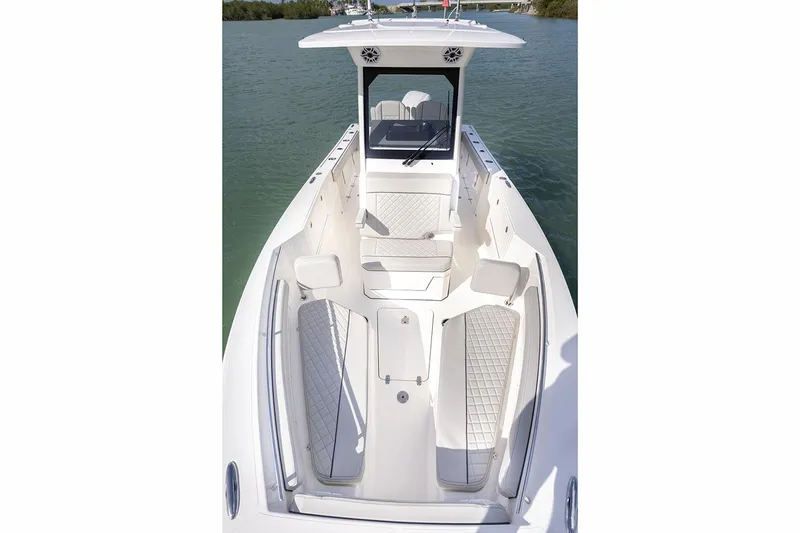 Slide: The Image of Manufacturer Provided Image: 2025 Pursuit S 248 Sport boat interior with seating and helm, on calm water. - 7