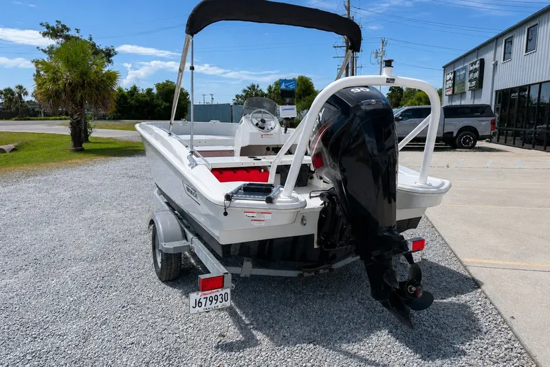 Slide: The Image of 2019 Boston Whaler 160 Super Sport boat on trailer, parked outdoors. - 8
