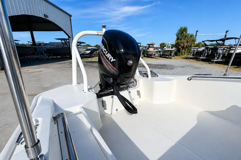 Slide: The Image of 2019 Boston Whaler 160 Super Sport with Mercury outboard motor in a boatyard setting. - 11