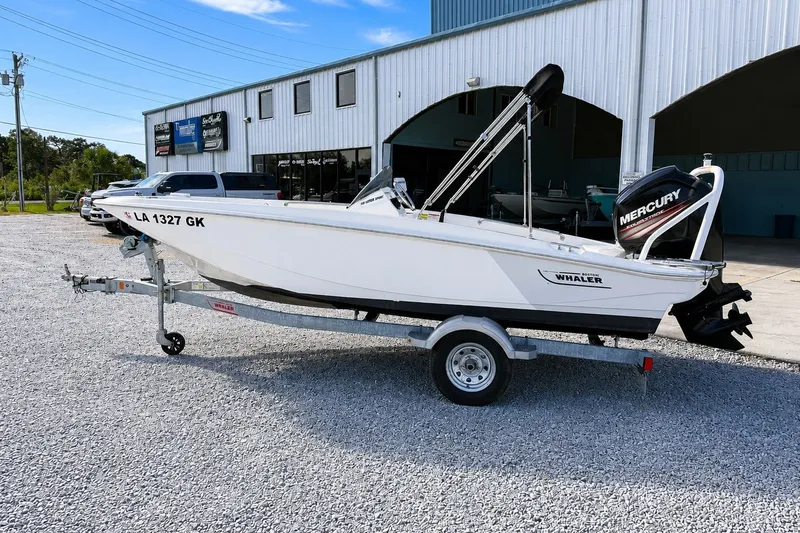 Slide: The Image of 2019 Boston Whaler 160 Super Sport boat on trailer, parked outside a building. - 9