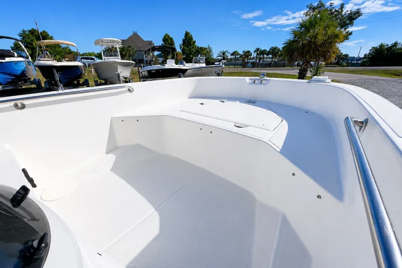 Slide: The Image of 2019 Boston Whaler 160 Super Sport boat interior with sleek white design and spacious seating. - 16