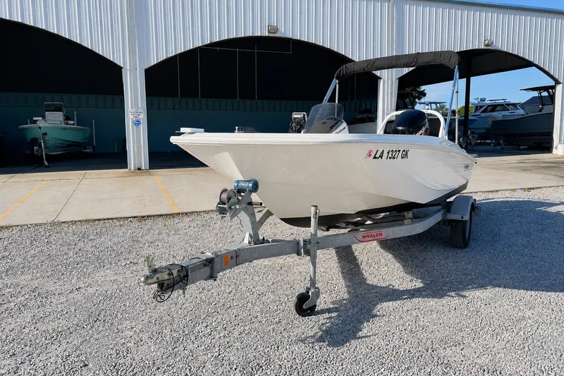 Slide: The Image of 2019 Boston Whaler 160 Super Sport boat on trailer, parked outside a storage facility. - 3