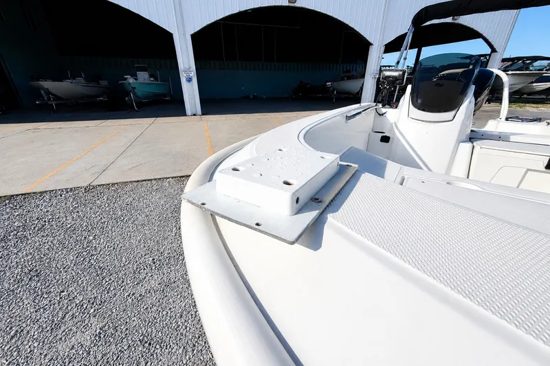 Slide: The Image of 2019 Boston Whaler 160 Super Sport boat docked, showcasing sleek design and spacious interior. - 17