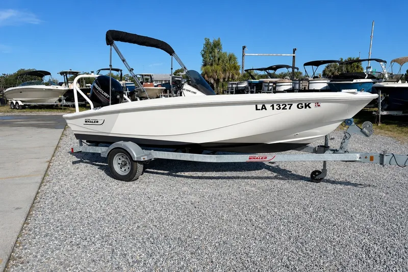Slide: The Image of 2019 Boston Whaler 160 Super Sport boat on trailer, parked outdoors. - 5