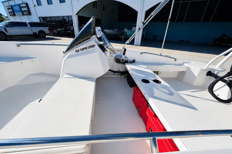 Slide: The Image of 2019 Boston Whaler 160 Super Sport interior with seating and storage compartments. - 21