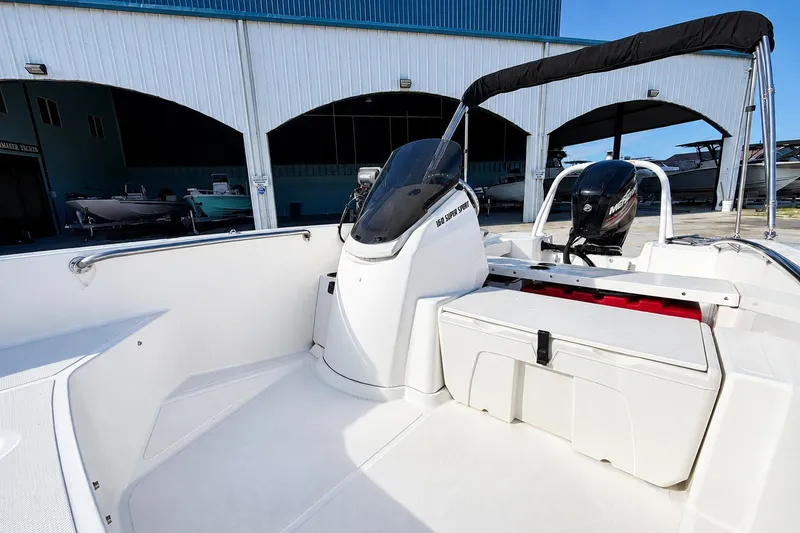 Slide: The Image of 2019 Boston Whaler 160 Super Sport boat interior with console and seating. - 20